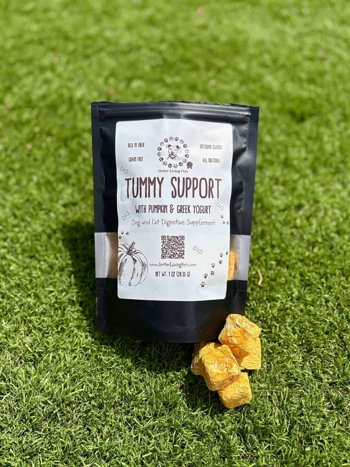Bag of 'Tummy Support' supplement with yellow chunks on grass