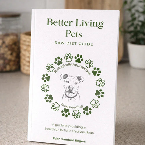 Book titled 'Better Living Pets Raw Diet Guide' on a surface with a kitchen background